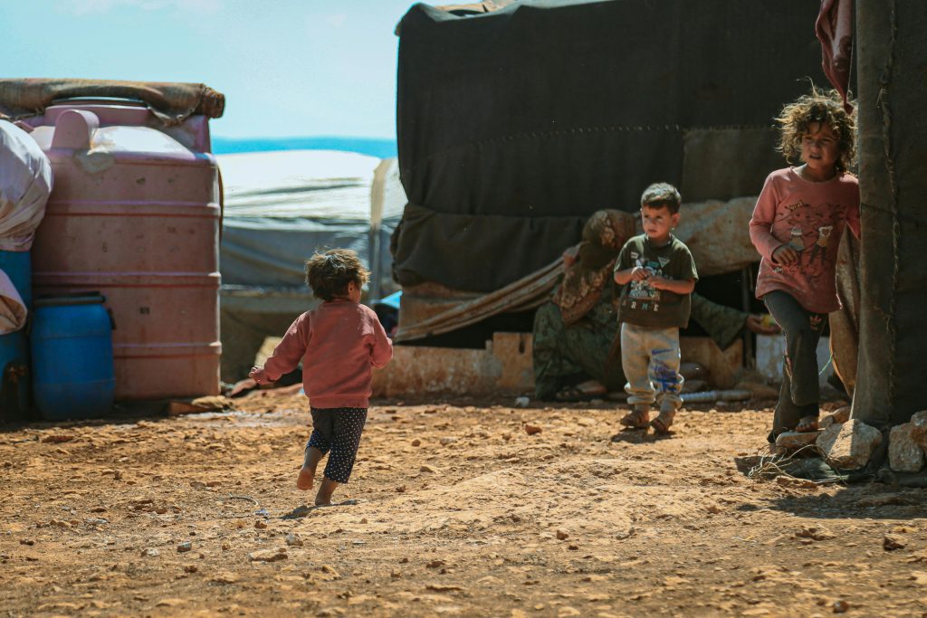 children playing by a tent