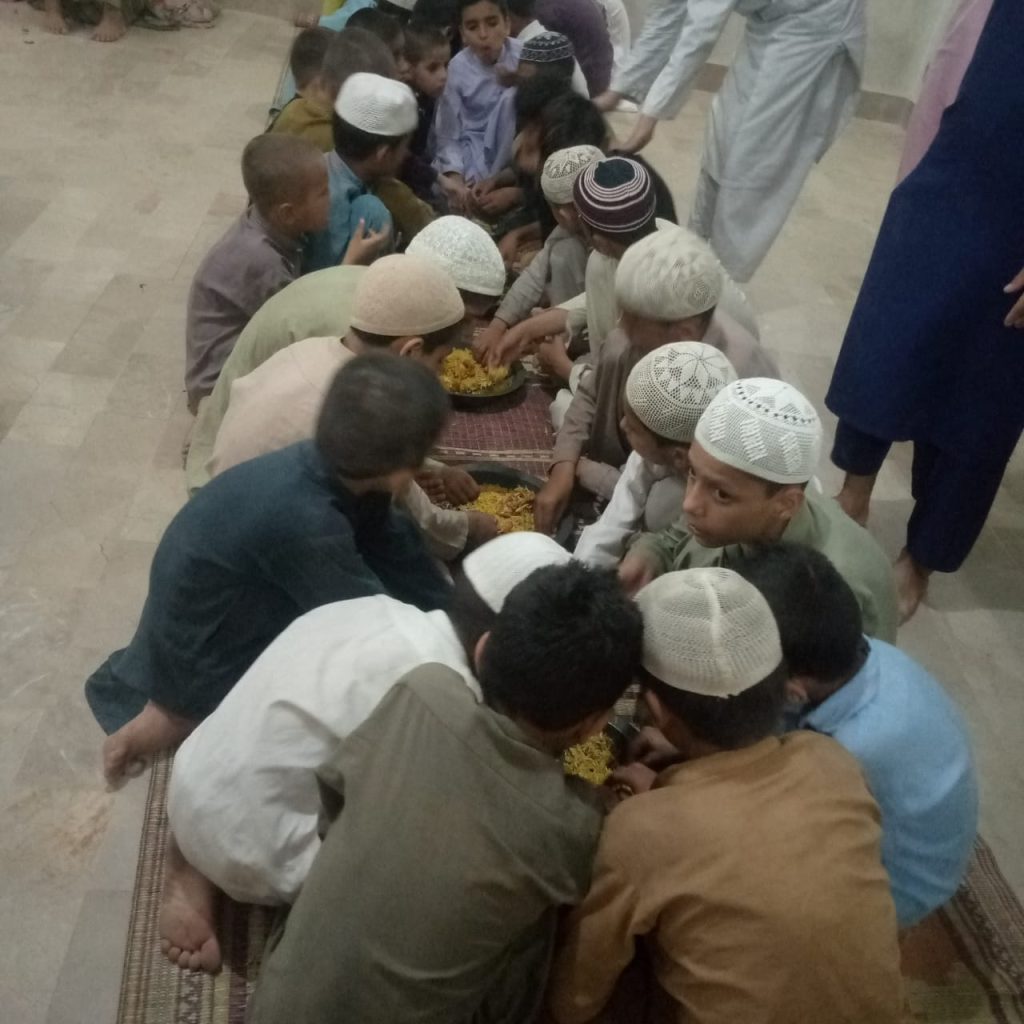 Children eating rice to break their Ramadan fast.