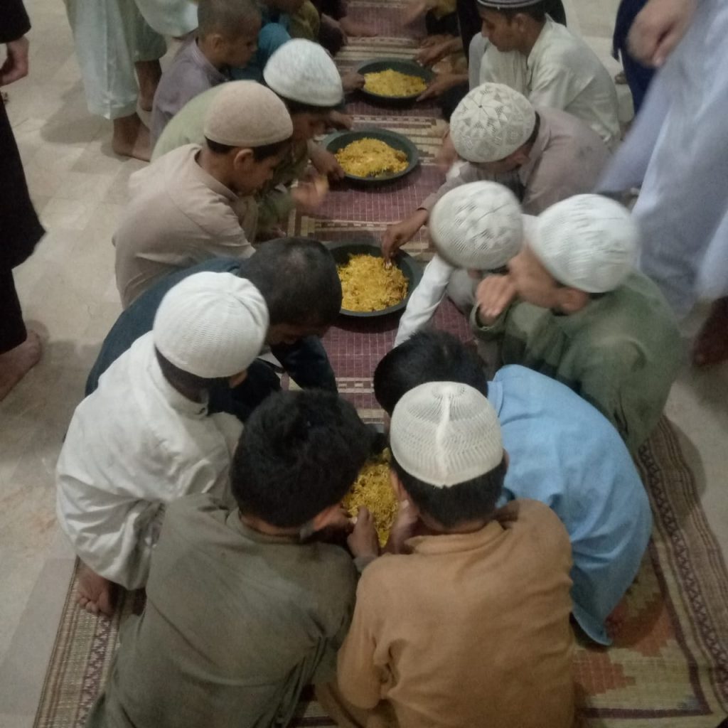 Children eating rice to break their Ramadan fast.