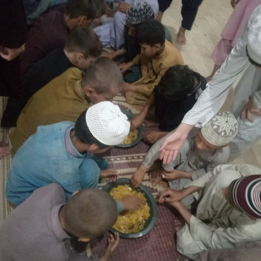 Children eating rice to break their Ramadan fast.